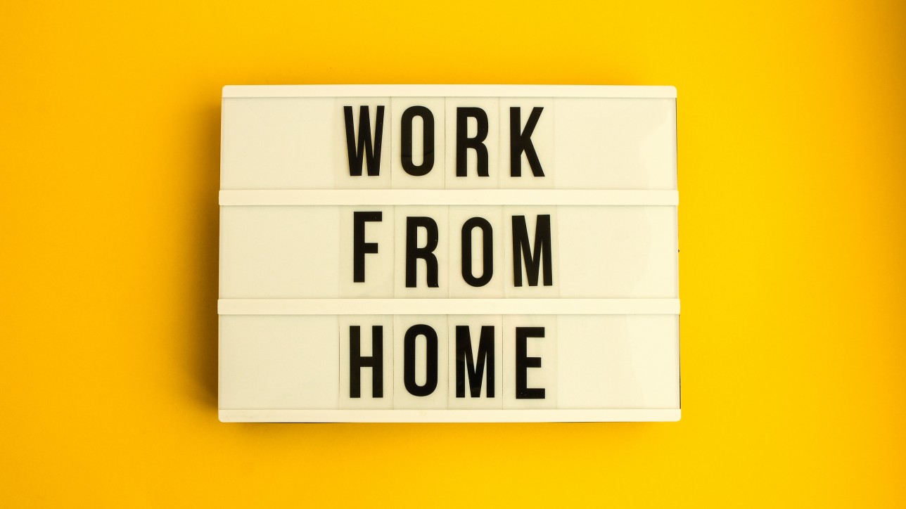 lightbox with text WORK FROM HOME in front yellow background, copy space, banner for freelance coronavirus quarantine isolation, teleworking